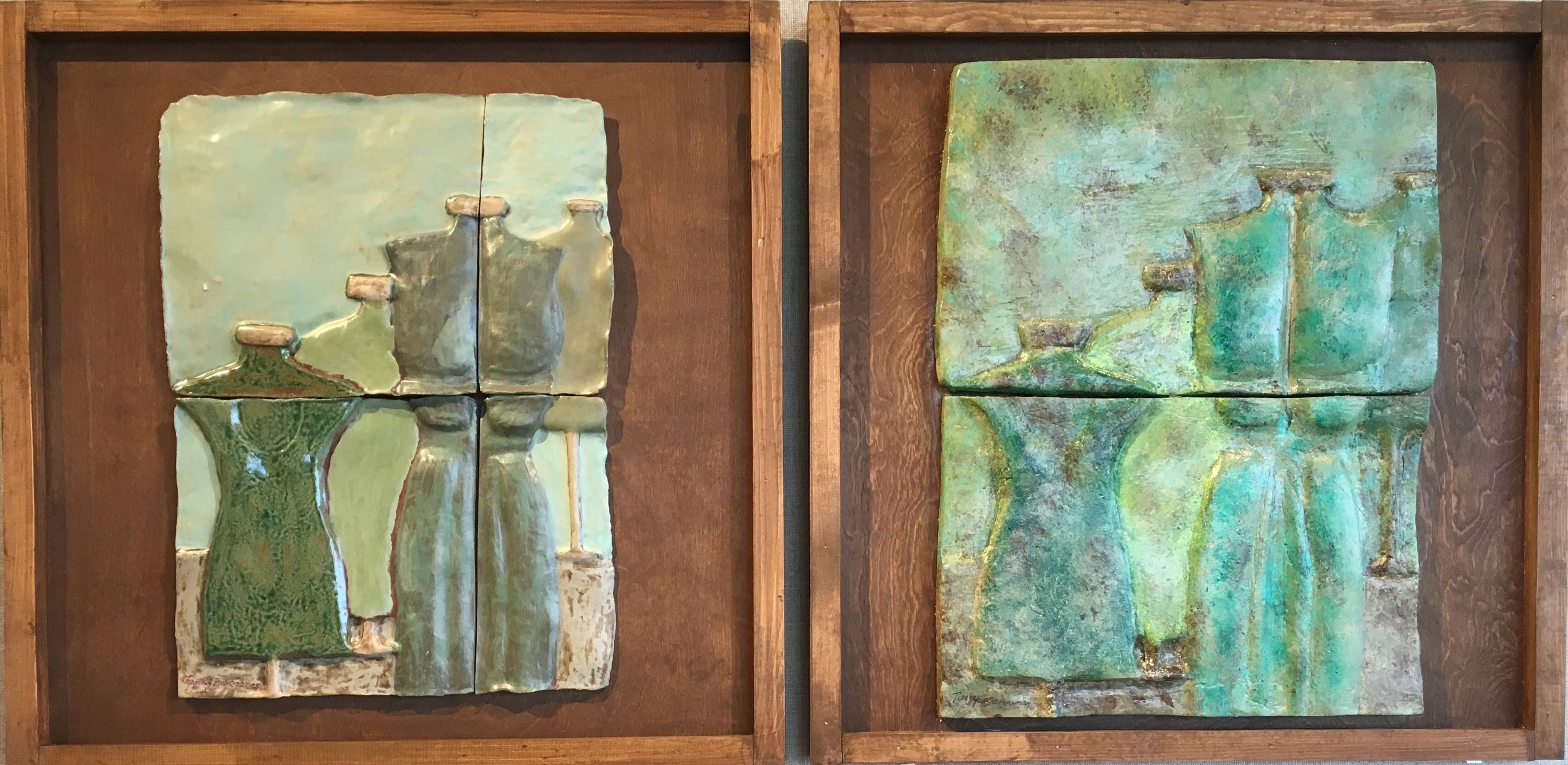 This dyptic is two wood framed ceramic reliefs. The one on the left is comprised of four tiles. They are arranged two wide by two tall. The heights are the same, but the tiles on the right are about one third of the entire width. The imagery depicts four dress forms in varying shades of muted green creating a diagonal from the middle left to the upper right. The background is a pale blue-green and the floor is a mottled tan. The relief on the right is the same composition, but is comprised of only two tiles, the image split in the middle horizontally. The colors are mottled with almost a sponging pattern to the piece. The colors are less distinct within the image and the saturation is more intense.