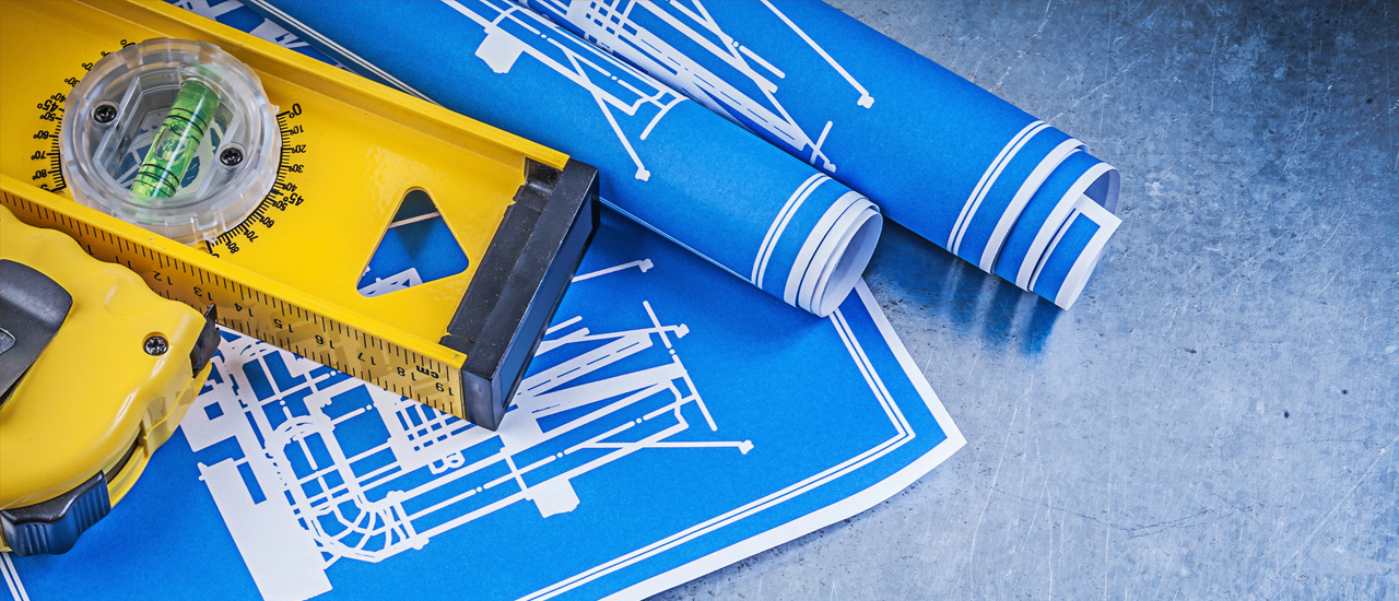 Blue construction drawings and level tape measure.