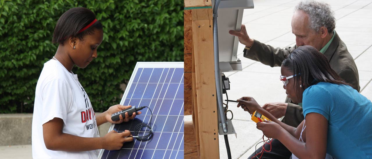 Professor and student work on solar panel controls.