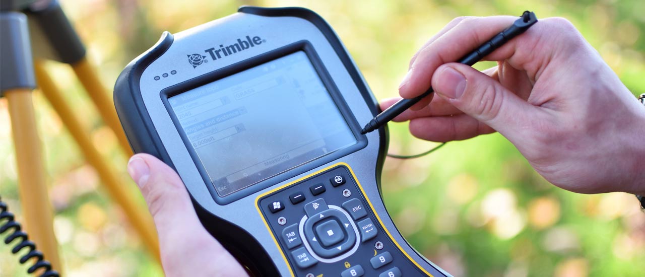 Student using a Trimble tool for surveying.